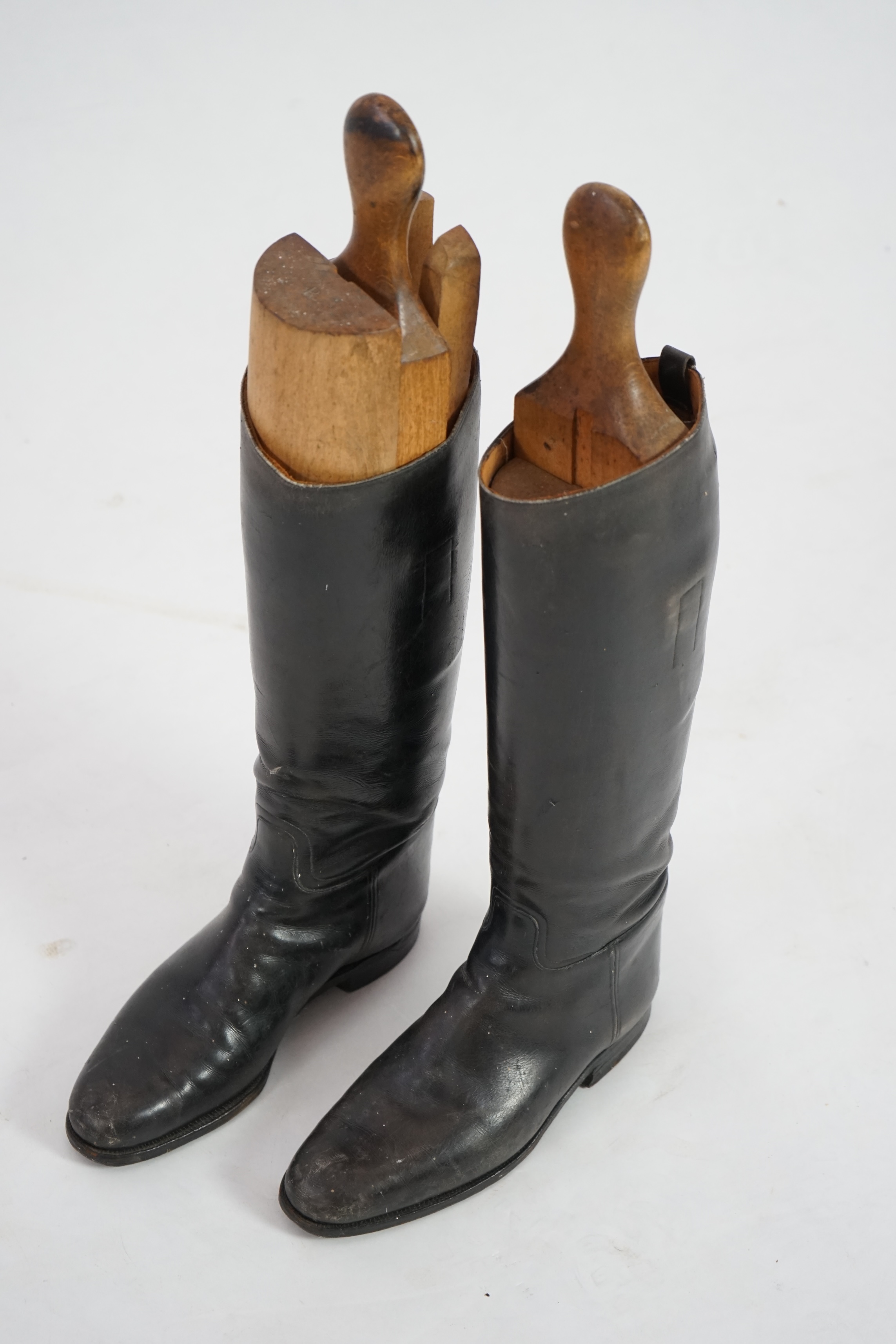 A pair of black leather riding boots